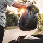 woman hand holding garbage bag for recycle cleaning